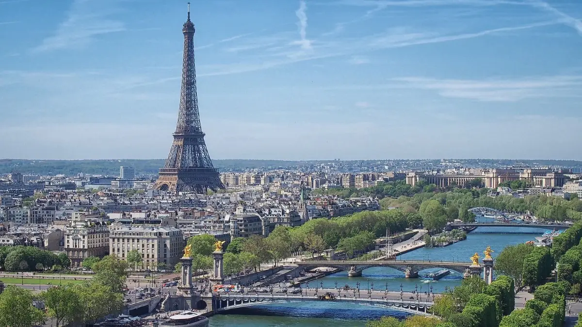 Seine River flows past the Eiffel Tower and iconic Paris bridges.