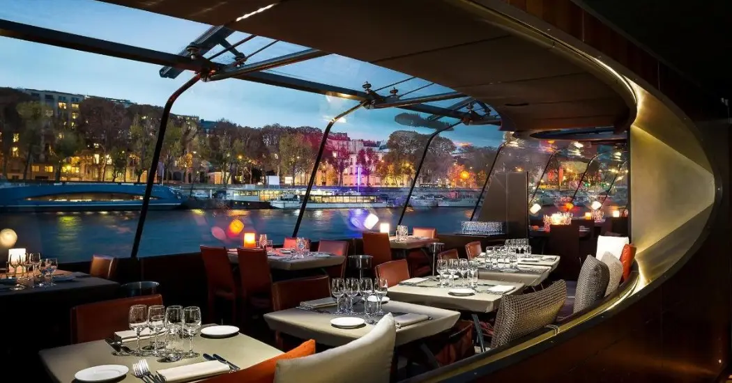 Romantic dinner cruise with modern interiors and river views.