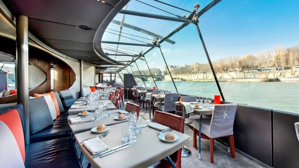 Scenic Paris lunch cruise with stylish table arrangements onboard.