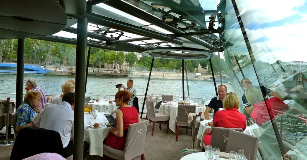 Paris lunch cruise with floor-to-ceiling windows and gourmet meals.
