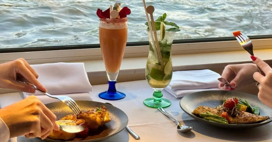  Fine dining on Seine cruise with river view and cocktails.