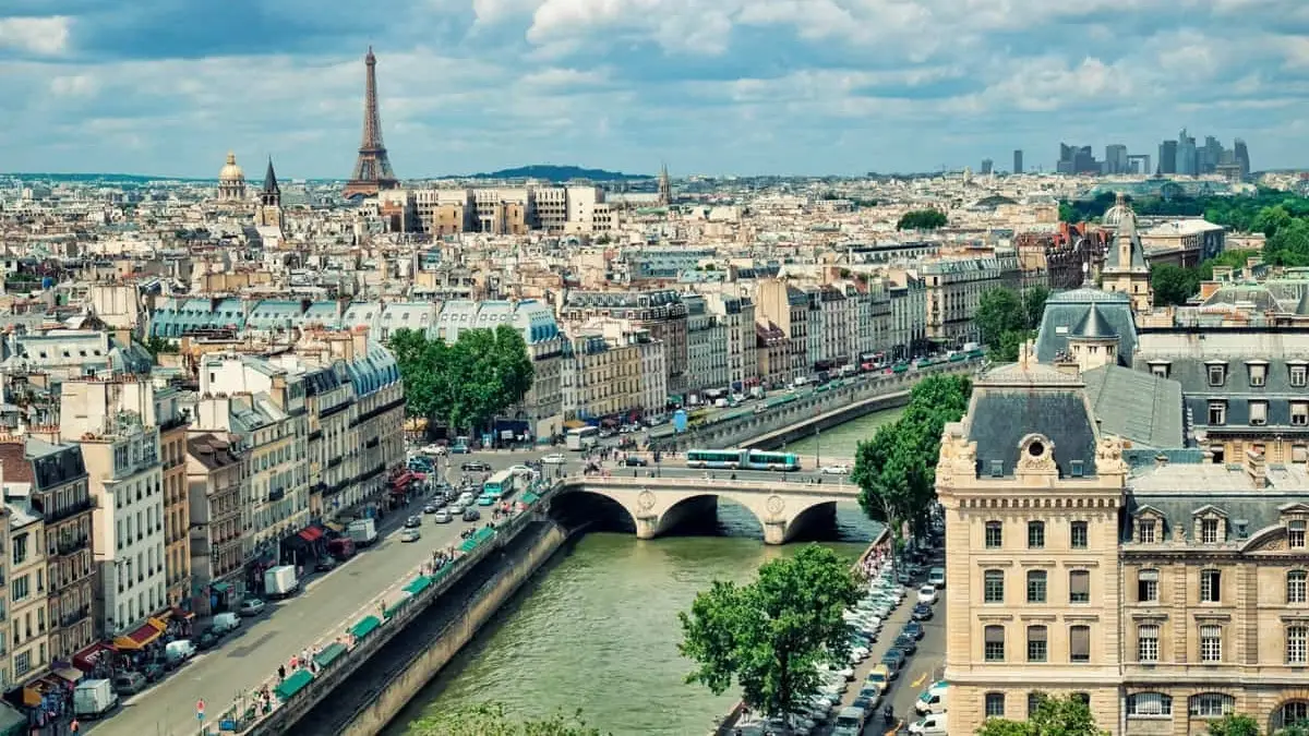 Panoramic view of the Seine River in Paris with Eiffel Tower and river cruise route visible through the city skyline. Panoramic view of the Seine River in Paris with Eiffel Tower and river cruise route visible through the city skyline.